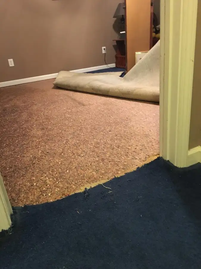 Carpet pad removal revealing water damage during Drying & Dehumidification in Lander